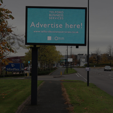 A photograph showing a digital advertising screen on the box road in Telford central