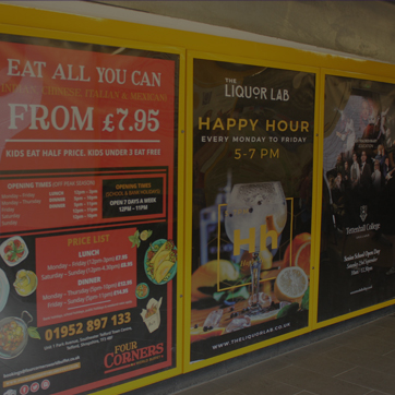 A photograph of advertising posters inside the pedestrian entrance to Southwater Multi-Storey Car Park