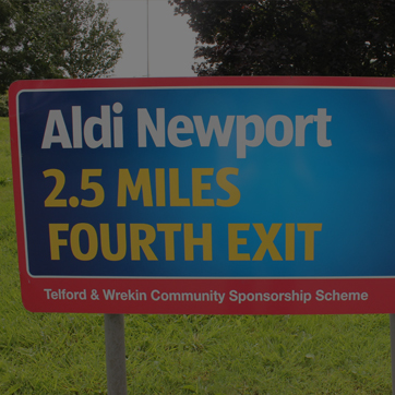 A photograph of a roundabout advertising sign