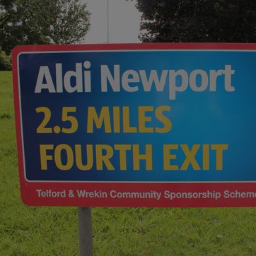 A photograph of a roundabout sign