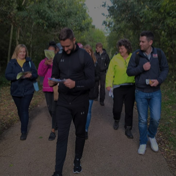 A photograph showing a mixed group of people walking outdoors