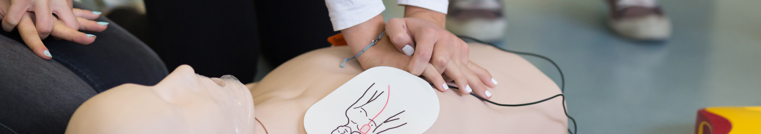 A photograph demonstrating the use of CPR on a dummy